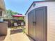 Backyard shed with a gazebo with chairs, backyard privacy fence, and an air conditioner at 8600 N Briar Patch Dr, Port Richey, FL 34668