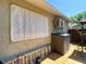 Exterior view of siding of home, utility unit, white privacy screen, shed, and a ladder at 8600 N Briar Patch Dr, Port Richey, FL 34668
