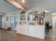 Well-lit wet bar with white cabinetry, shelving, and a view to the outdoor patio at 8600 N Briar Patch Dr, Port Richey, FL 34668