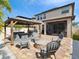 Spacious backyard with an outdoor gazebo, fire pit, seating area, and well manicured landscaping at 8630 Campus Woods Way, New Port Richey, FL 34655