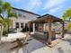 Backyard featuring a gazebo with seating, a hammock, and well-maintained landscaping at 8630 Campus Woods Way, New Port Richey, FL 34655