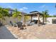 Backyard oasis featuring a beautiful gazebo, comfortable seating, fire pit, and lush landscaping at 8630 Campus Woods Way, New Port Richey, FL 34655