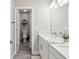 Well-lit bathroom with double vanity, marble countertops, and modern fixtures at 8630 Campus Woods Way, New Port Richey, FL 34655