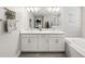 Bathroom featuring double sinks, a modern bathtub, and stylish accents at 8630 Campus Woods Way, New Port Richey, FL 34655