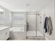 Modern bathroom with a double vanity, large soaking tub, and a glass enclosed shower at 8630 Campus Woods Way, New Port Richey, FL 34655