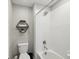 Shower/Tub in well-lit bathroom with sleek tile, shelving, and modern fixtures at 8630 Campus Woods Way, New Port Richey, FL 34655