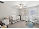 Bedroom with a white crib, dresser, rocking chair and decor at 8630 Campus Woods Way, New Port Richey, FL 34655