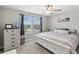 Bright bedroom features natural light, a ceiling fan, and a modern, neutral color scheme at 8630 Campus Woods Way, New Port Richey, FL 34655