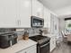 Well-equipped kitchen showcasing stainless steel appliances, countertops, and backsplash at 8630 Campus Woods Way, New Port Richey, FL 34655