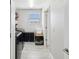 Functional laundry room features tile floors, window, washer, and dryer at 8630 Campus Woods Way, New Port Richey, FL 34655