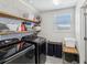 Bright laundry room features modern appliances, open shelving and plenty of storage space for convenience at 8630 Campus Woods Way, New Port Richey, FL 34655