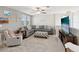 Bright upstairs living room featuring a sectional sofa, media center, and comfortable chair at 8630 Campus Woods Way, New Port Richey, FL 34655