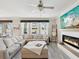 Bright living room featuring a fireplace, plush sectional sofa, and stylish decor at 8630 Campus Woods Way, New Port Richey, FL 34655