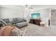 Cozy upstairs living room with plush sofa, TV, and comfortable seating area at 8630 Campus Woods Way, New Port Richey, FL 34655