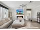 Cozy living room with fireplace, ceiling fan, and comfortable seating at 8630 Campus Woods Way, New Port Richey, FL 34655