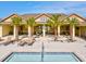 Community poolside with lounge chairs, seating, fans, and views of the community pool at 8630 Campus Woods Way, New Port Richey, FL 34655
