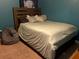Calm and inviting bedroom featuring a comfortable queen-sized bed, stylish headboard, and cozy beanbag chair at 9007 49Th E Ave, Palmetto, FL 34221