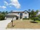 Two-story home with a two-car garage, stucco walls, manicured lawn, and a mailbox in the front at 9007 49Th E Ave, Palmetto, FL 34221