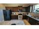 Well-equipped kitchen with dark wood cabinets, stainless steel appliances, and a stylish island at 9007 49Th E Ave, Palmetto, FL 34221