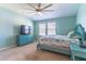 This bedroom features a ceiling fan, a dresser, and a double window for natural light at 9103 Carolina Wren Dr, Tampa, FL 33626