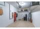 Well-organized garage with epoxy floors, shelving, water heater, and ample space for storage and vehicles at 9103 Carolina Wren Dr, Tampa, FL 33626