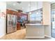 Modern kitchen with stainless steel appliances, wood cabinets, and a breakfast bar at 9103 Carolina Wren Dr, Tampa, FL 33626