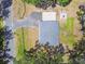 This aerial view shows the home, driveway, and a unique outdoor living area with a fire pit at 9226 Dan Lynn St, Brooksville, FL 34601