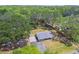 The aerial image highlights the home's setting among mature trees, the driveway, and fenced property at 9226 Dan Lynn St, Brooksville, FL 34601
