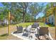 An inviting backyard features a paver fire pit area with outdoor seating at 9226 Dan Lynn St, Brooksville, FL 34601