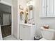 This bathroom is stylishly designed with white cabinets, a vanity, and elegant marble flooring at 9226 Dan Lynn St, Brooksville, FL 34601
