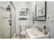 Well-lit bathroom with a glass-enclosed shower, modern vanity, and stylish decor at 9226 Dan Lynn St, Brooksville, FL 34601