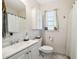 This bathroom features a modern vanity, updated fixtures, and marble tile flooring at 9226 Dan Lynn St, Brooksville, FL 34601