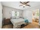 A spacious bedroom with ample natural light, ceiling fan, and an attached dining room at 9226 Dan Lynn St, Brooksville, FL 34601