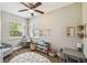 A well-lit playroom with a comfortable armchair, a play kitchen and toy organizer at 9226 Dan Lynn St, Brooksville, FL 34601