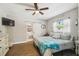 A cozy bedroom with a barn-style closet door and modern ceiling fan at 9226 Dan Lynn St, Brooksville, FL 34601