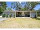 Well-kept home with a welcoming front porch and blooming hanging plants at 9226 Dan Lynn St, Brooksville, FL 34601