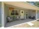 Close up of a cozy front porch with seating and decorative plants at 9226 Dan Lynn St, Brooksville, FL 34601