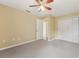 Carpeted bedroom with closet, window, ceiling fan, and neutral wall color at 9434 Hayward Rd, Spring Hill, FL 34608