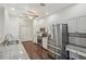 Kitchen with stainless steel appliances, granite countertops and bright white cabinetry at 9434 Hayward Rd, Spring Hill, FL 34608