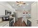 Modern kitchen with stainless steel appliances, hardwood floors, and breakfast bar at 9434 Hayward Rd, Spring Hill, FL 34608