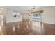 Open-concept living room with hardwood floors and sliding glass doors leading to the pool at 9434 Hayward Rd, Spring Hill, FL 34608