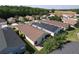 Aerial view of a well-maintained home with a dark roof and a brick-paved backyard at 1006 Sweet Jasmine Dr, Trinity, FL 34655