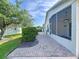 Enjoy outdoor living on this screened-in lanai with brick pavers and a ceiling fan at 1006 Sweet Jasmine Dr, Trinity, FL 34655