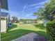 Beautiful backyard with lush green lawn and serene lake views under a clear blue sky at 1006 Sweet Jasmine Dr, Trinity, FL 34655