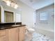 Bright bathroom with granite vanity, marble floors, and shower-tub combination at 1006 Sweet Jasmine Dr, Trinity, FL 34655