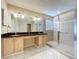 Bathroom featuring dual sinks, granite countertops, and a glass-enclosed shower at 1006 Sweet Jasmine Dr, Trinity, FL 34655