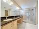 Bright bathroom featuring double vanity, glass shower, and neutral tile at 1006 Sweet Jasmine Dr, Trinity, FL 34655