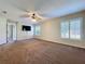 Spacious bedroom featuring a ceiling fan, carpet flooring, and plantation shutters at 1006 Sweet Jasmine Dr, Trinity, FL 34655