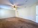 A well-lit bedroom with neutral walls, carpet flooring, and a ceiling fan at 1006 Sweet Jasmine Dr, Trinity, FL 34655