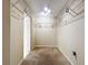 Carpeted walk-in closet with custom shelving, and neutral colored walls at 1006 Sweet Jasmine Dr, Trinity, FL 34655
